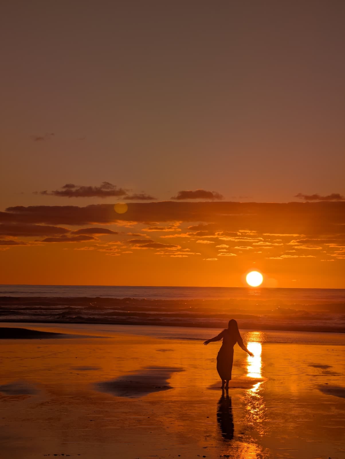 Esther on a west coast New Zealand beach at sunset